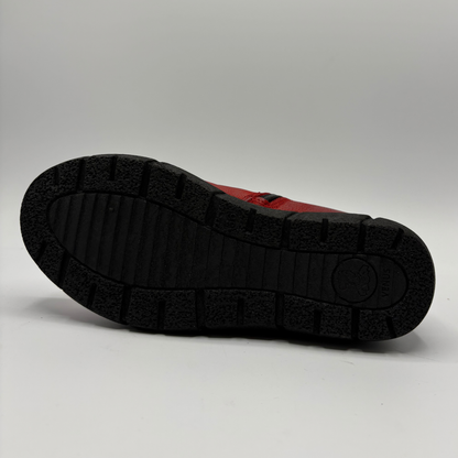 Bottom view of a red short boot with colourful buttons, a black outsole and a pull on heel tab