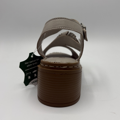 Brown sandal with a tag on a white background