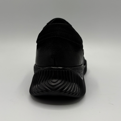 Back view of a black leather sneaker with a supportive outsole