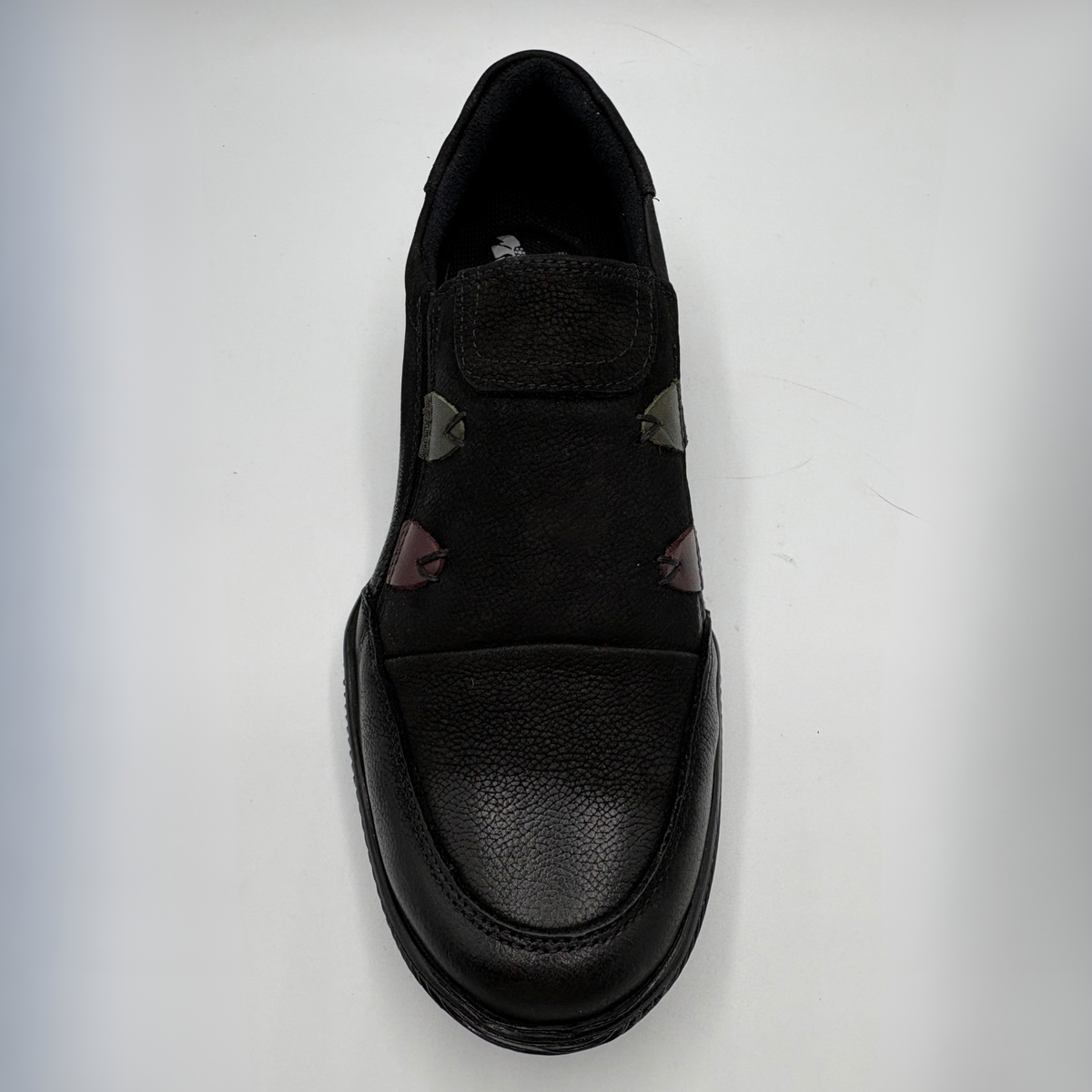 Top facing view of a black leather sneaker with a supportive outsole