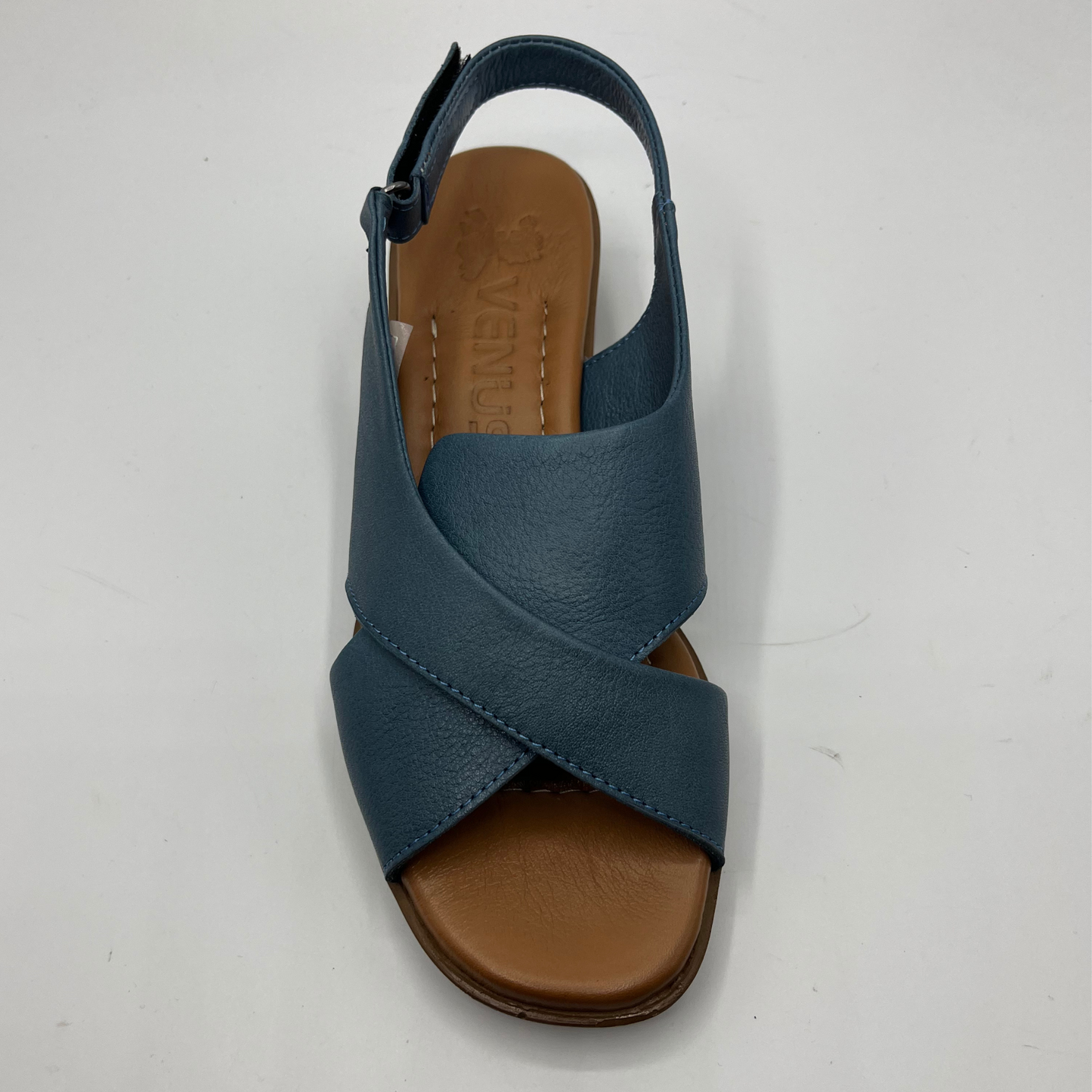 Top view of a blue cross strapped sandal with an adjustable slingback strap with a short heel.