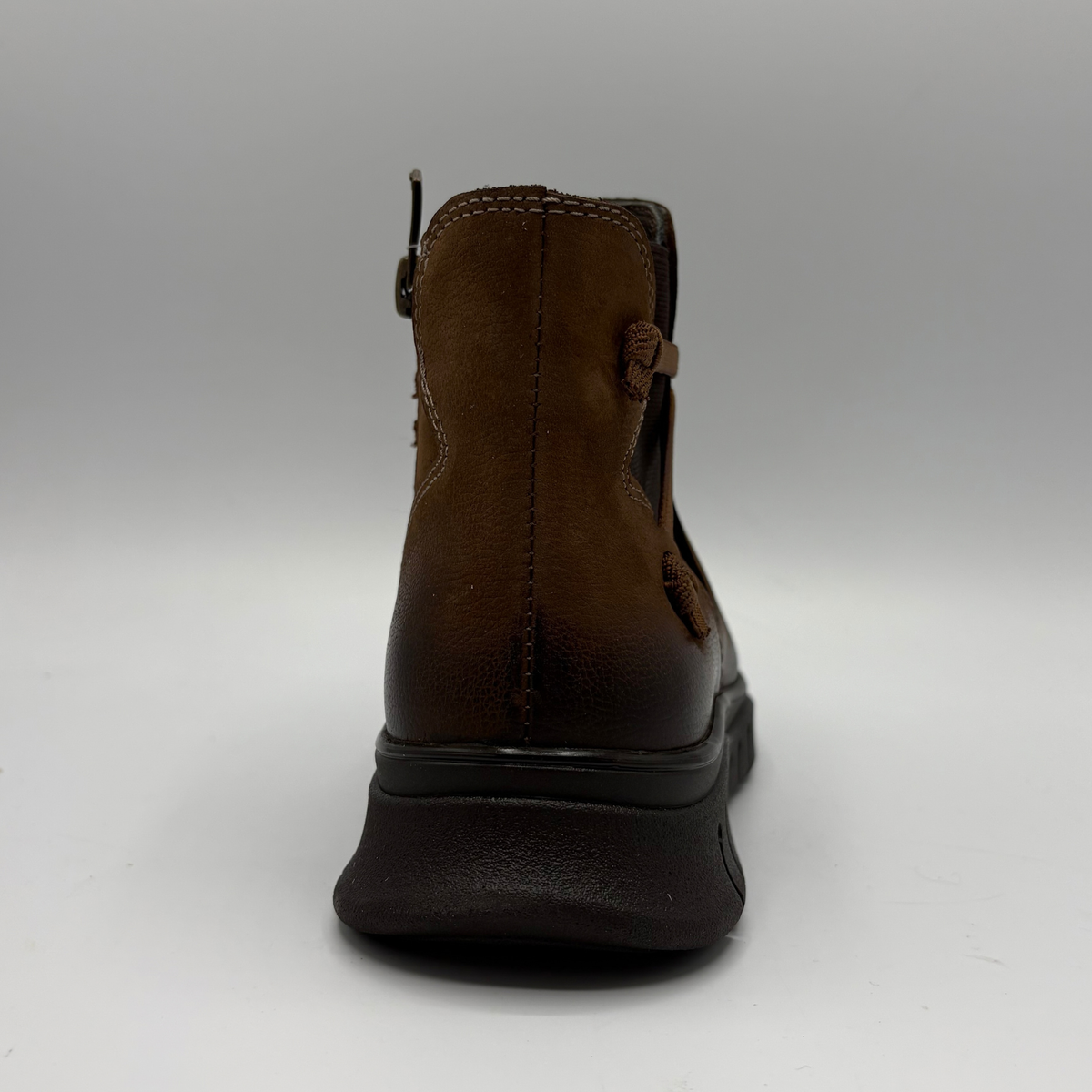 Back view of a brown leather chelsea boot with an elastic side gore and inside zipper