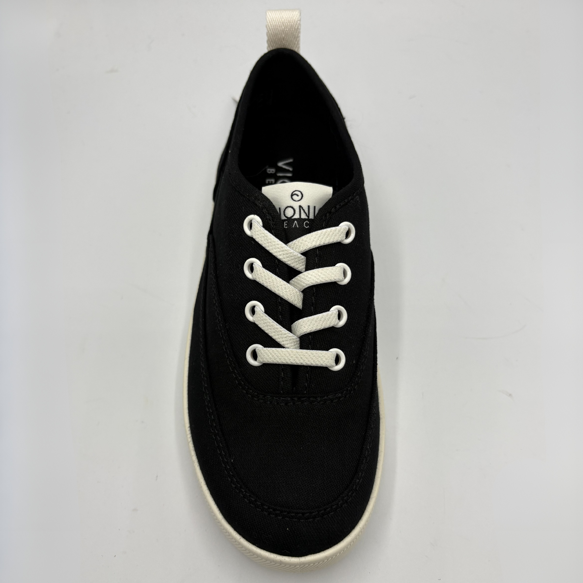 A black sneaker with white laces