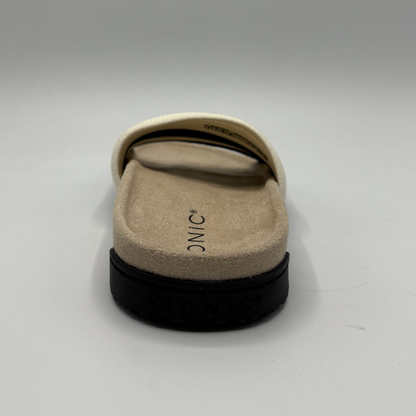 Beige sandal with black sole on a white background