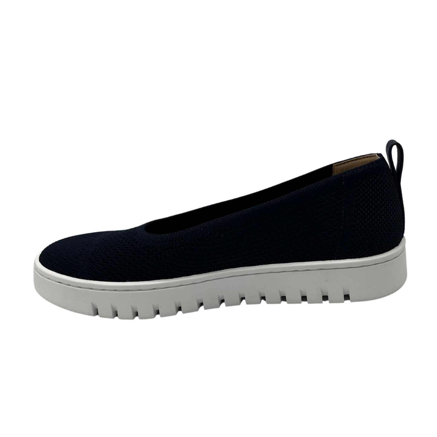 Left facing view of navy knit flat shoe with removable insole, rounded toe and pull on heel tab.