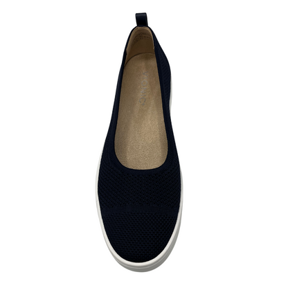 Top view of navy knit flat shoe with removable insole, rounded toe and pull on heel tab.