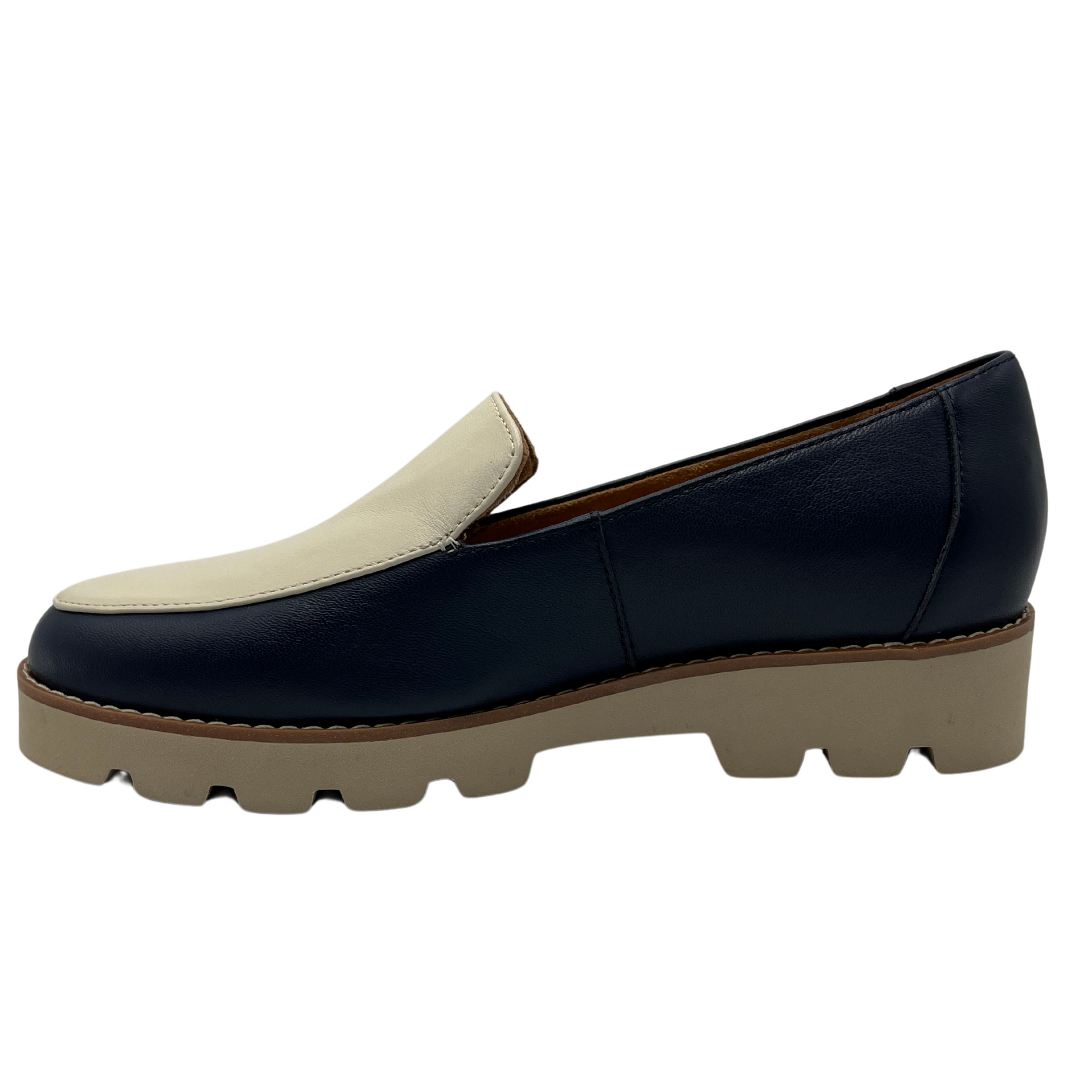 Left facing view of navy and cream leather loafer with chunky rubber outsole