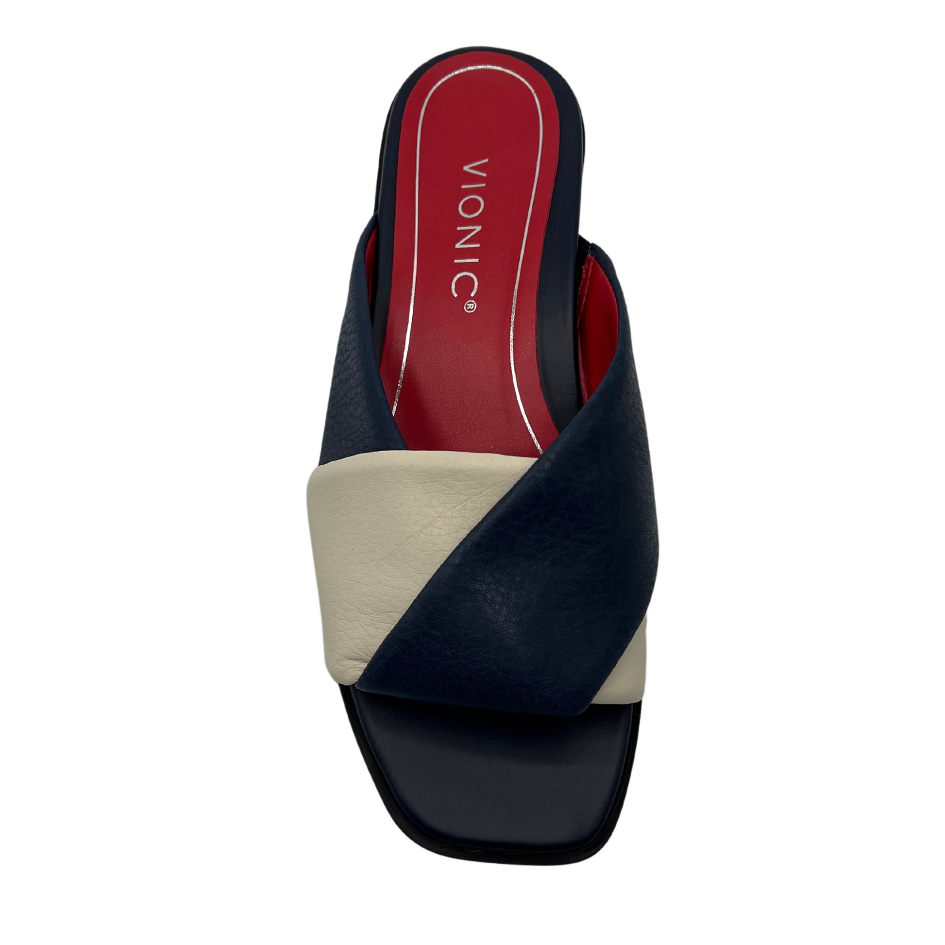 Top view of navy and cream leather slip on sandal with red inner lining and square toe