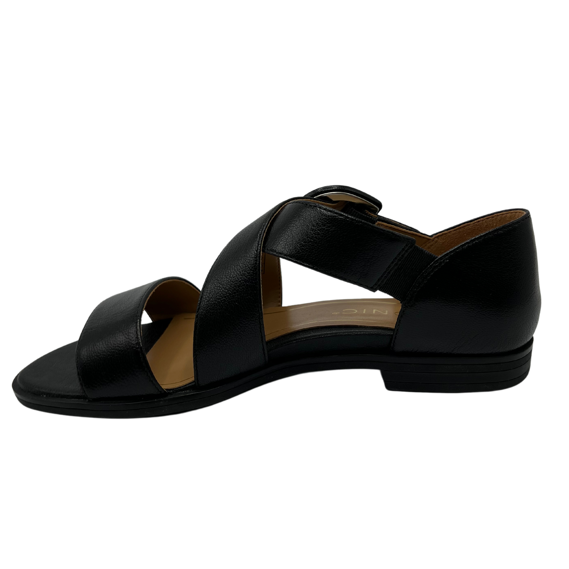 Left facing view of black leather sandal with low heel and criss cross straps
