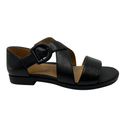 Right facing view of black leather sandal with criss cross straps, rounded toe and low heel