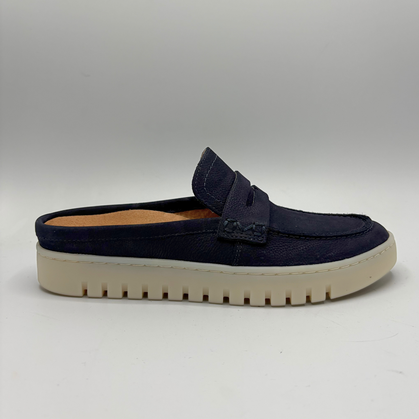 Right facing view of a navy slip on mule
