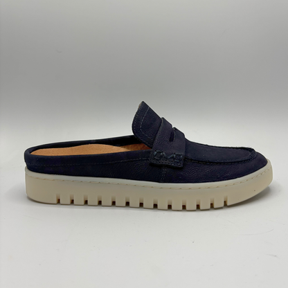 Right facing view of a navy slip on mule