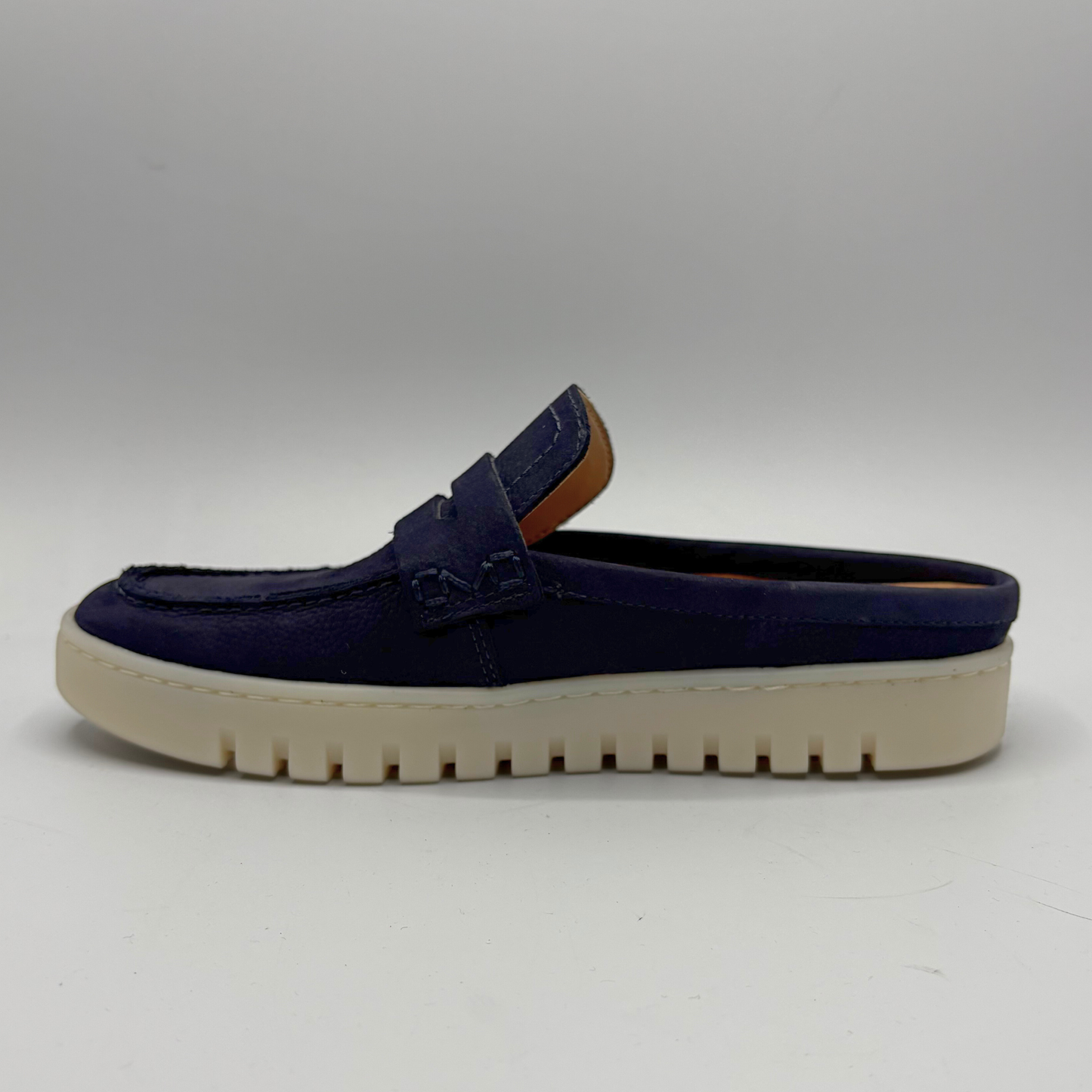 Left facing view of a navy slip on mule