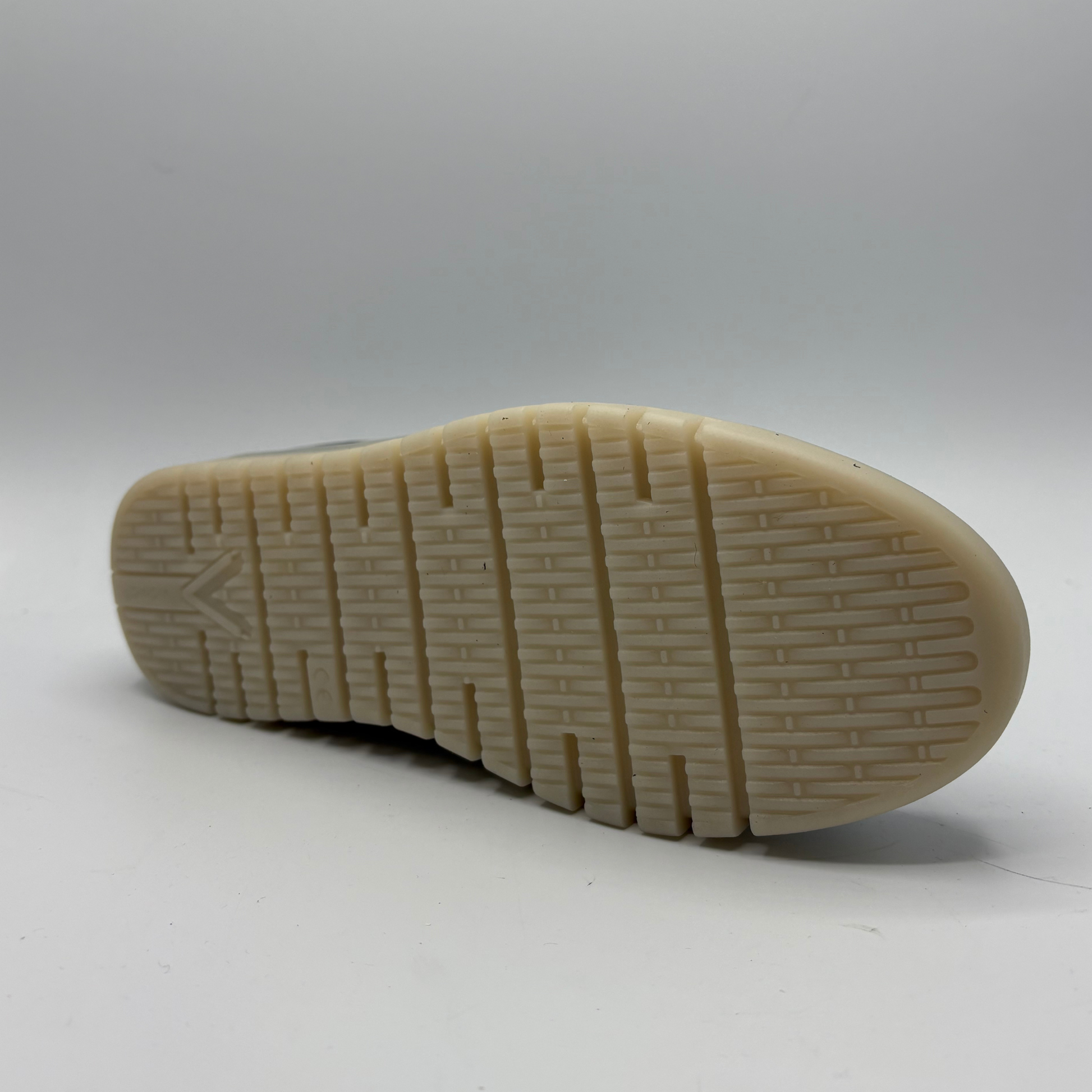 Bottom view of a navy slip on mule