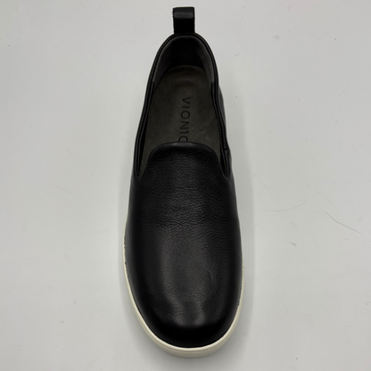 Black slip-on shoe on a light gray background