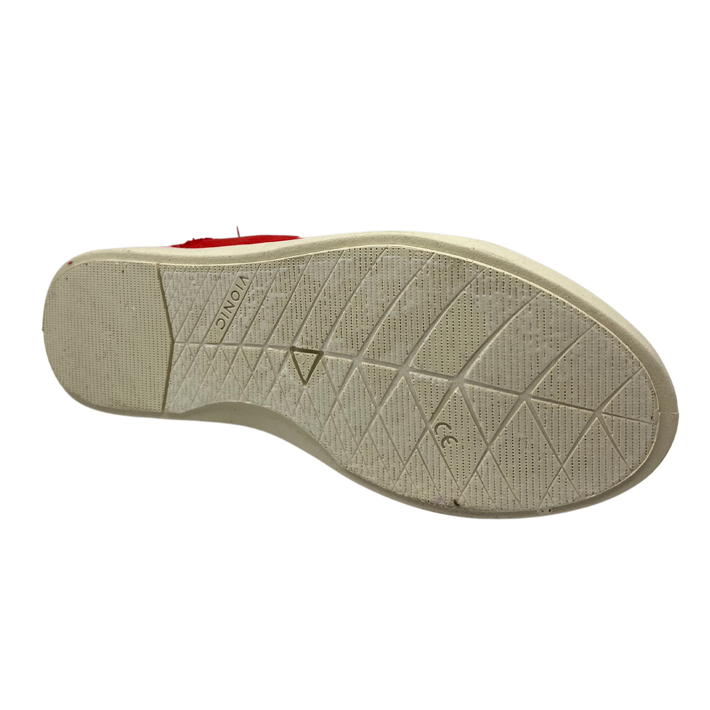 Bottom view of a red canvas sneaker with white rubber outsole