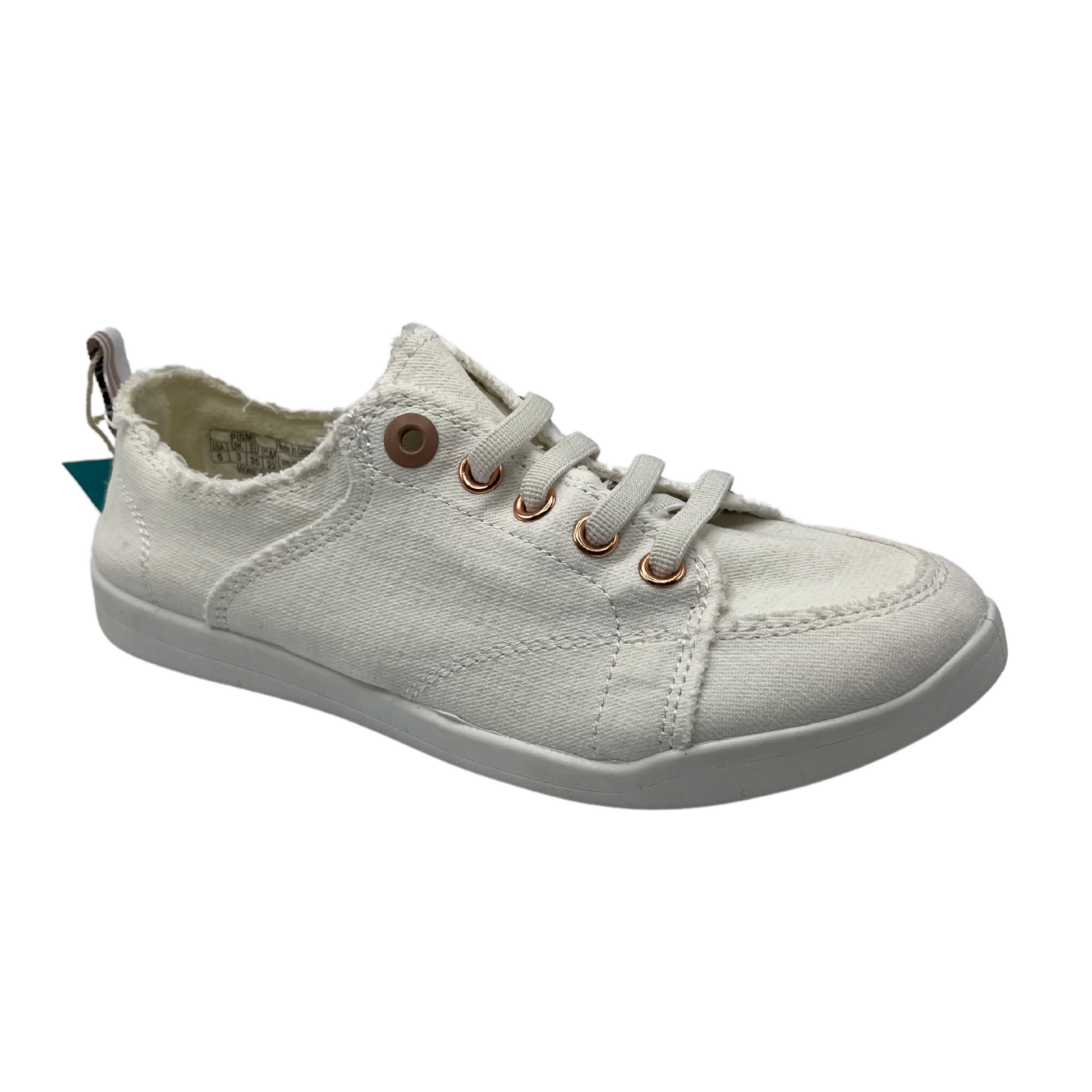 45 degree angled view of white canvas shoe with white rubber outsole and white laces