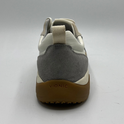 Gray and beige sneaker with brown sole on a white background