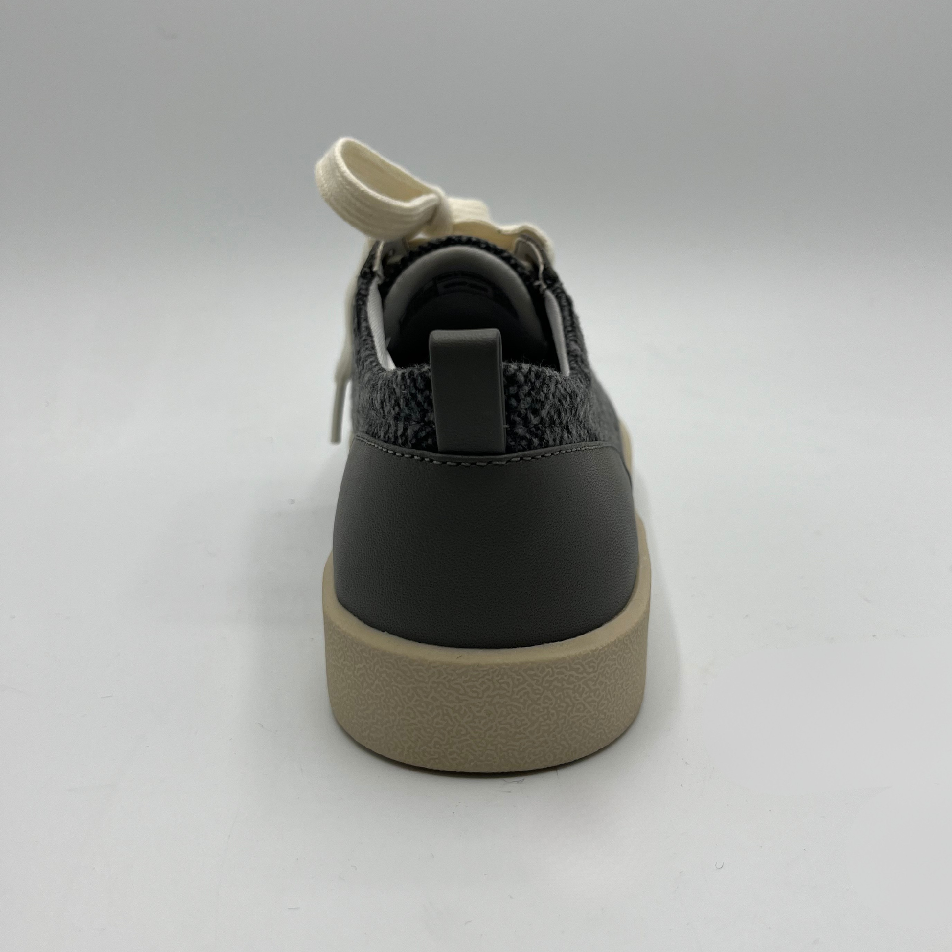 Grey and beige sneaker on a light gray background