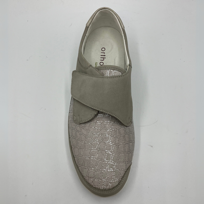 Top view of a grey sneaker with a velcro strap and a contoured footbed.