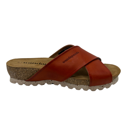 Right facing view of leather sandal with red criss-cross straps and cork foodbed