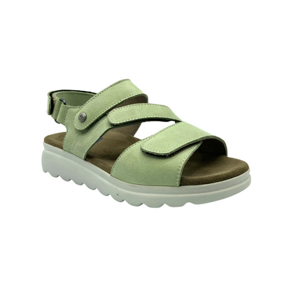 Angled front view of a light green sandal by Wolky.