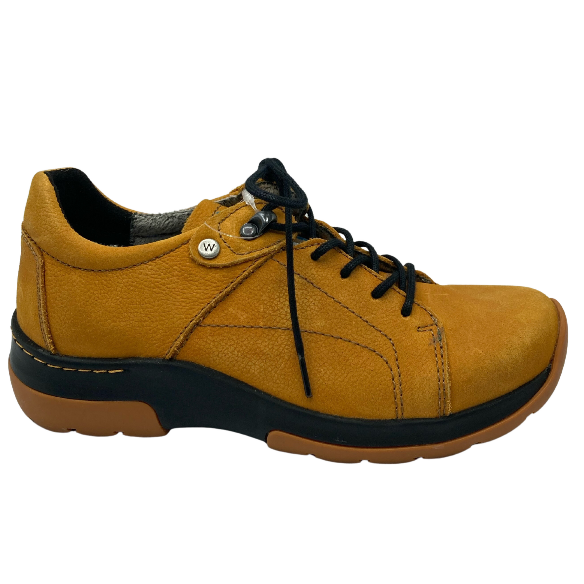 Right facing view of yellow leather sneaker with thick rubber outsole and black laces