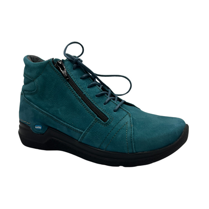 45 degree angled view of a teal suede short boot with matching laces and black outsole.