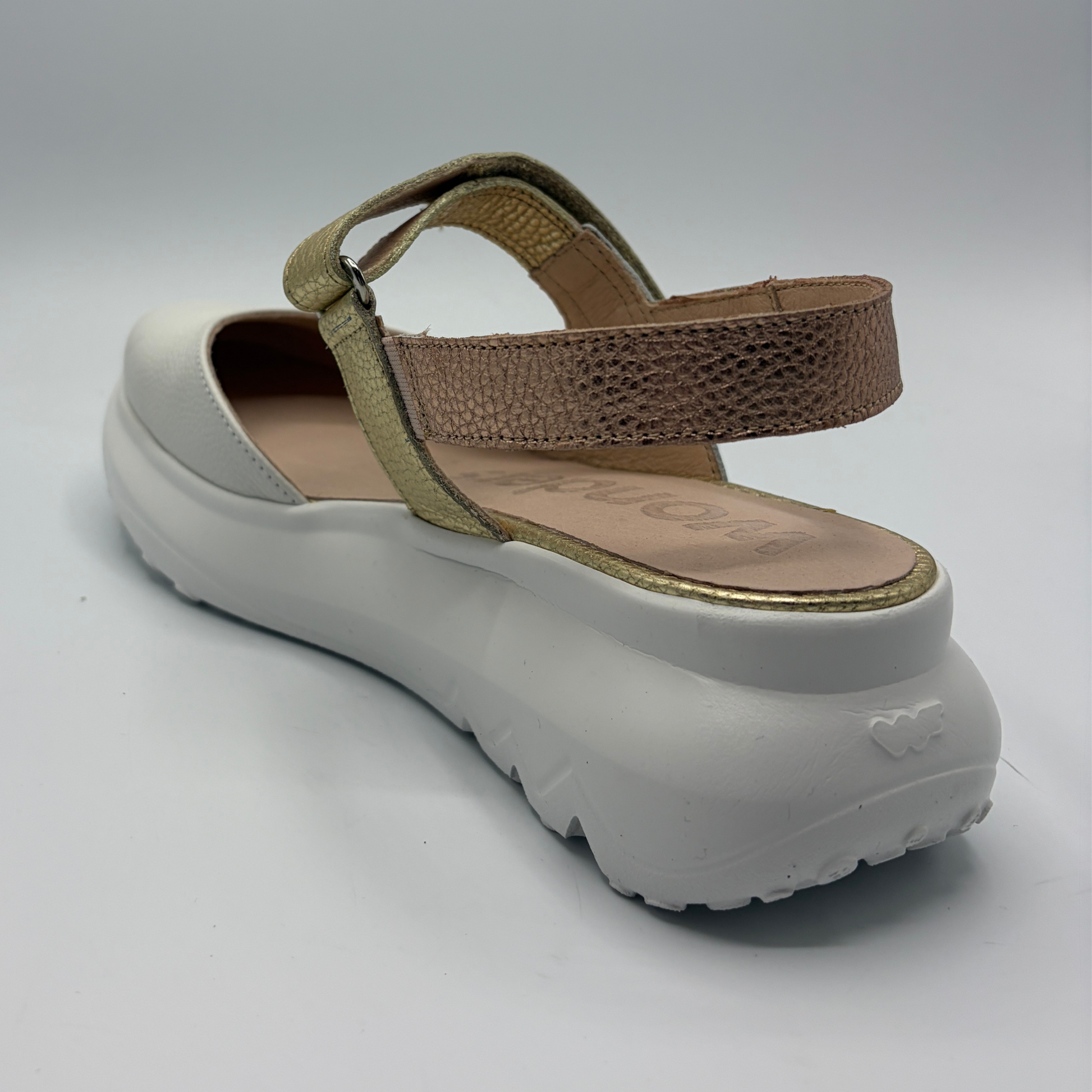 White sandal with brown strap on a white background