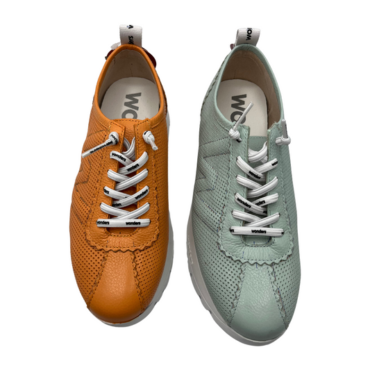Top view two sneakers side by side. One is orange and one is mint. Both have white branded laces and pull on tabs