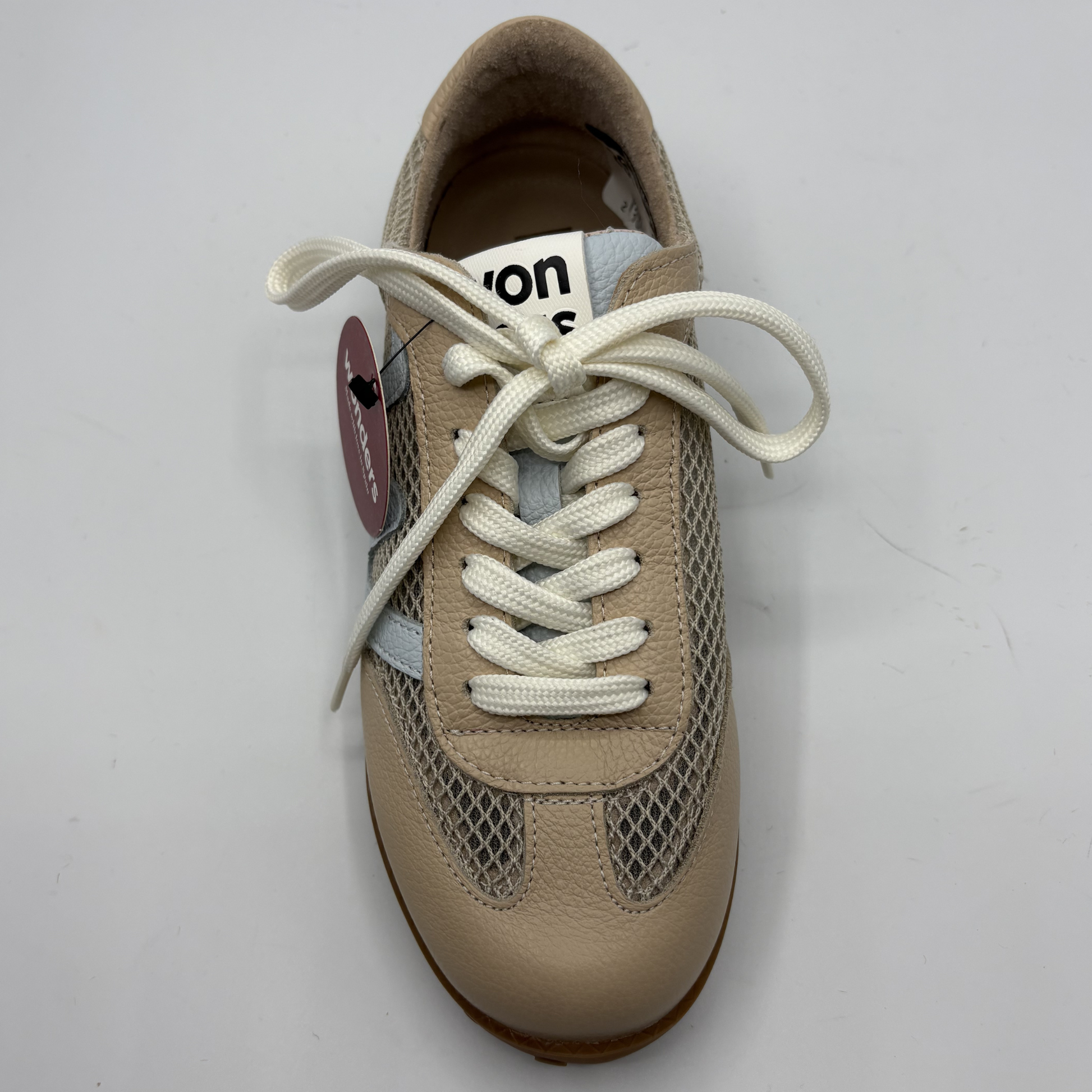 Beige sneaker with white laces on a light gray background