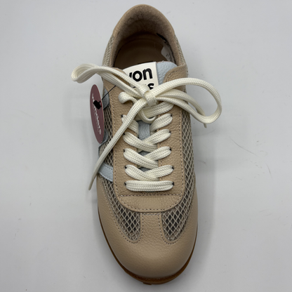 Beige sneaker with white laces on a light gray background