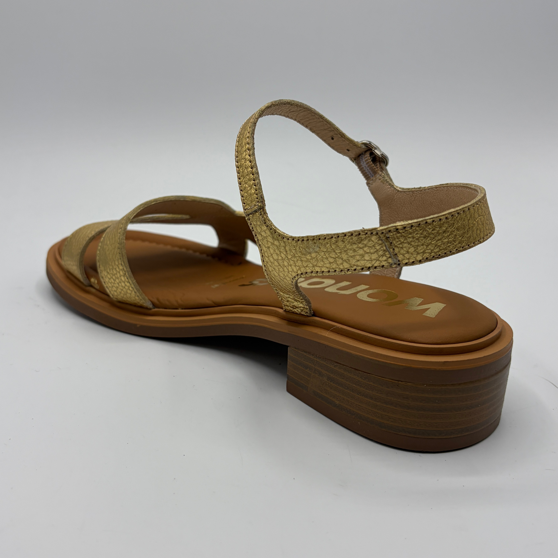 Brown sandal with 'Wonders' branding on a white background