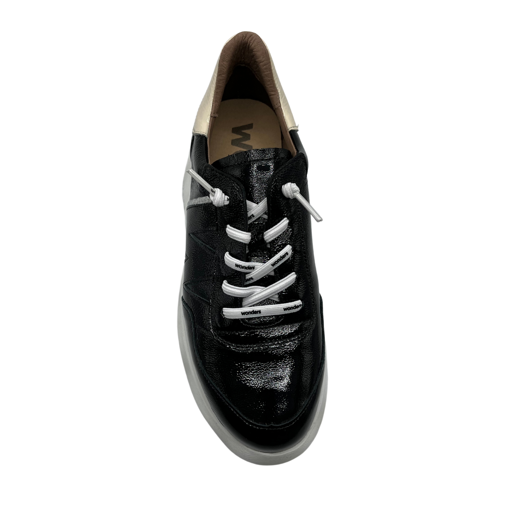 Top view of black patent leather sneaker with a padded heel and platform sole