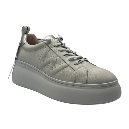 45 degree angled view of leather sneaker with W on the side. White platform outsole
