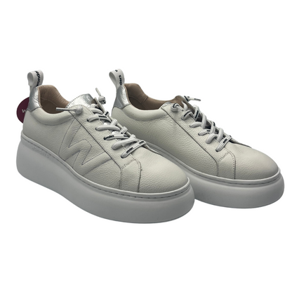 45 degree angled view of a pair of leather sneakers with white platform sole