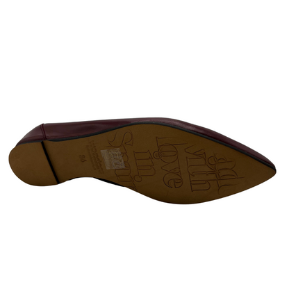 Bottom view of wine coloured shoe with wedge heel and pointed toe