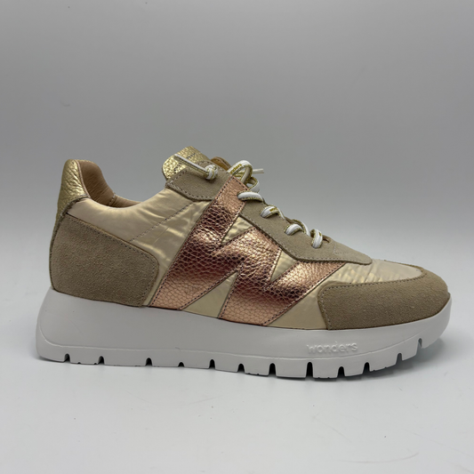 Beige and rose gold sneaker on a gray background