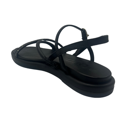 Back angled view of black leather sandal with padded sole, rhinestone detail and square toe