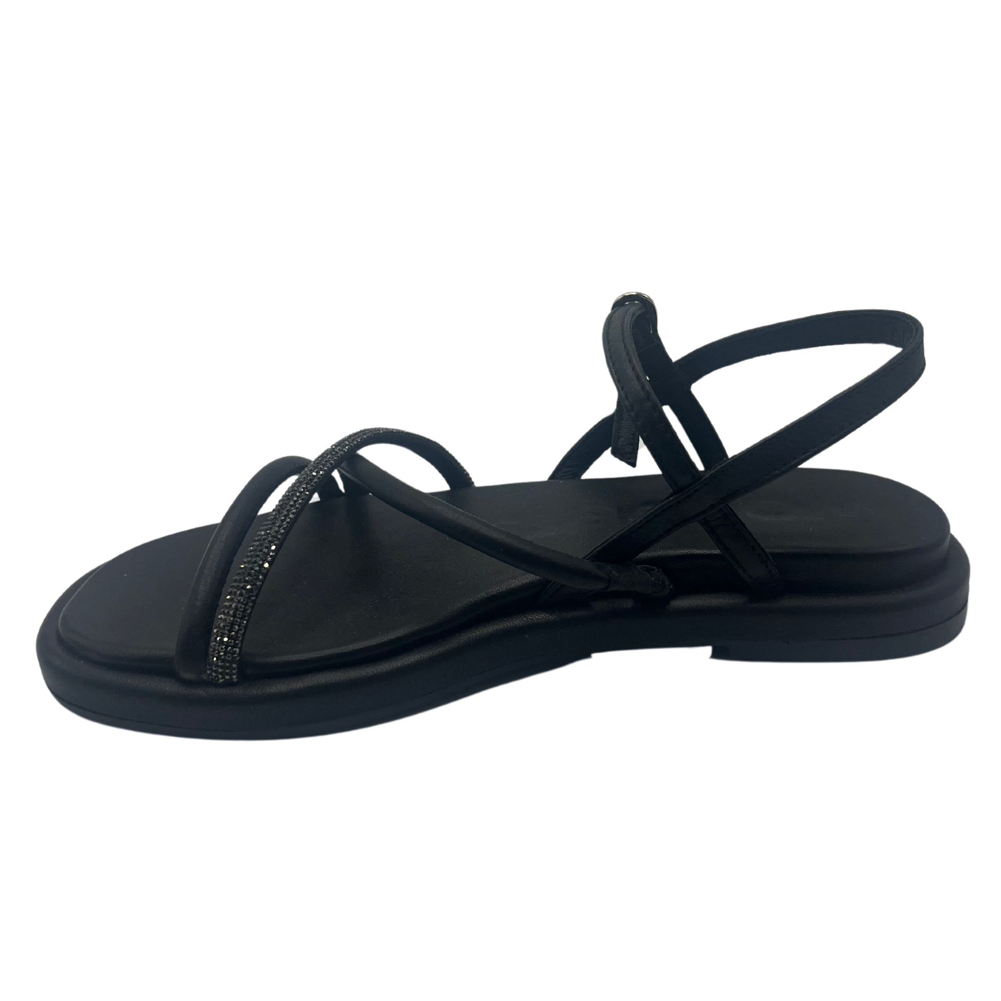 Left facing view of black leather sandal with padded sole, rhinestone detail and square toe