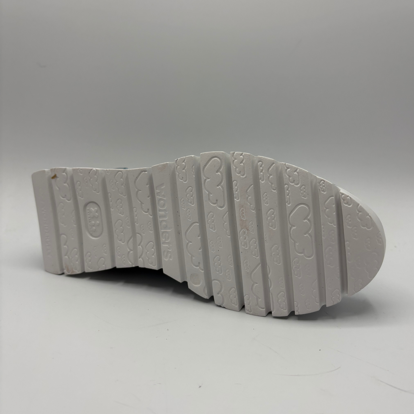 Gray sole of a shoe with brand logo on a white background