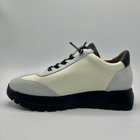 White and gray sneaker with black sole on a light gray background