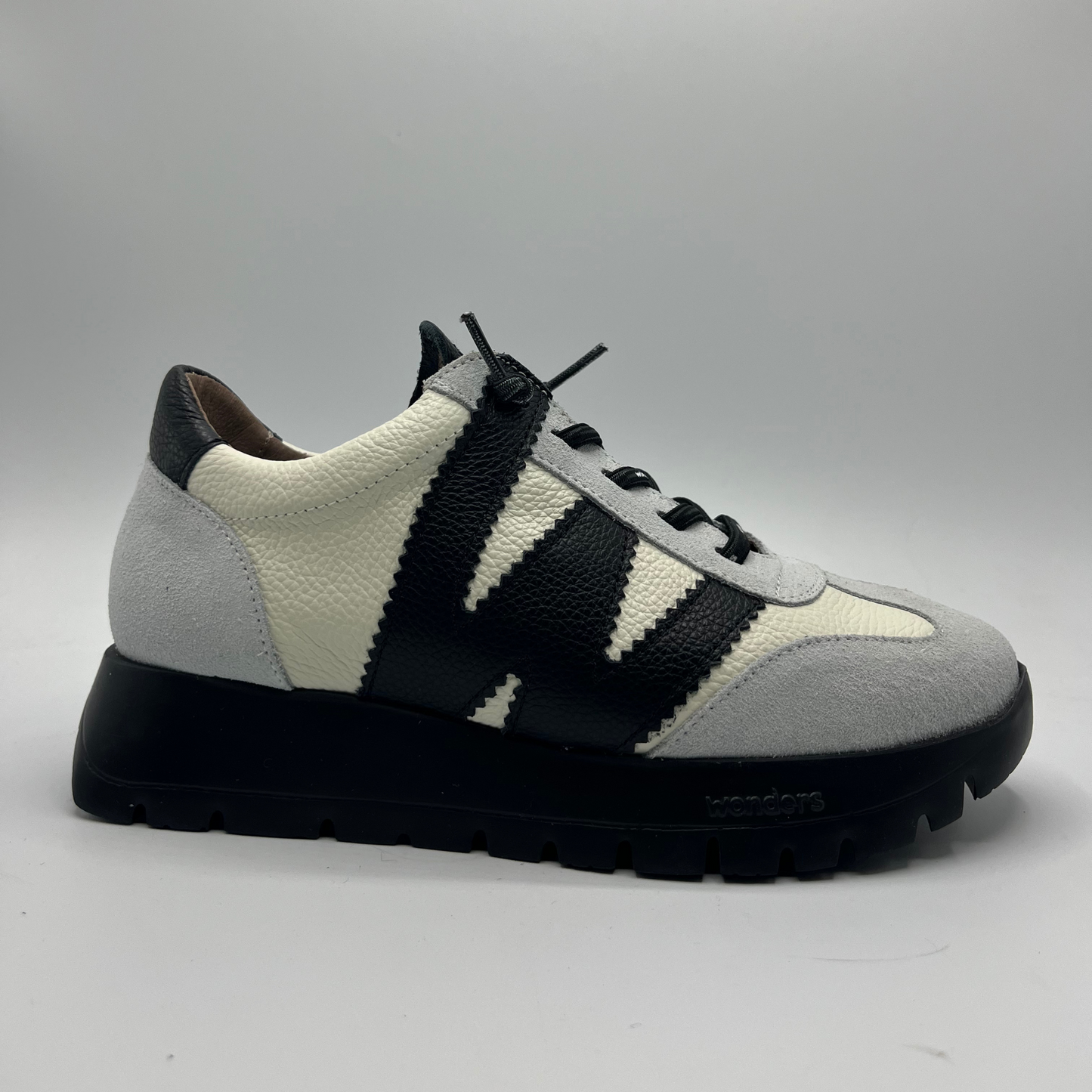 Sneaker with black and white pattern on a gray background