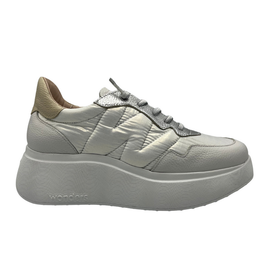 Right facing view of a white and silver leather sneaker with a padded gold collar. A quilted W on the side and ultralight white platform rubber outsole.