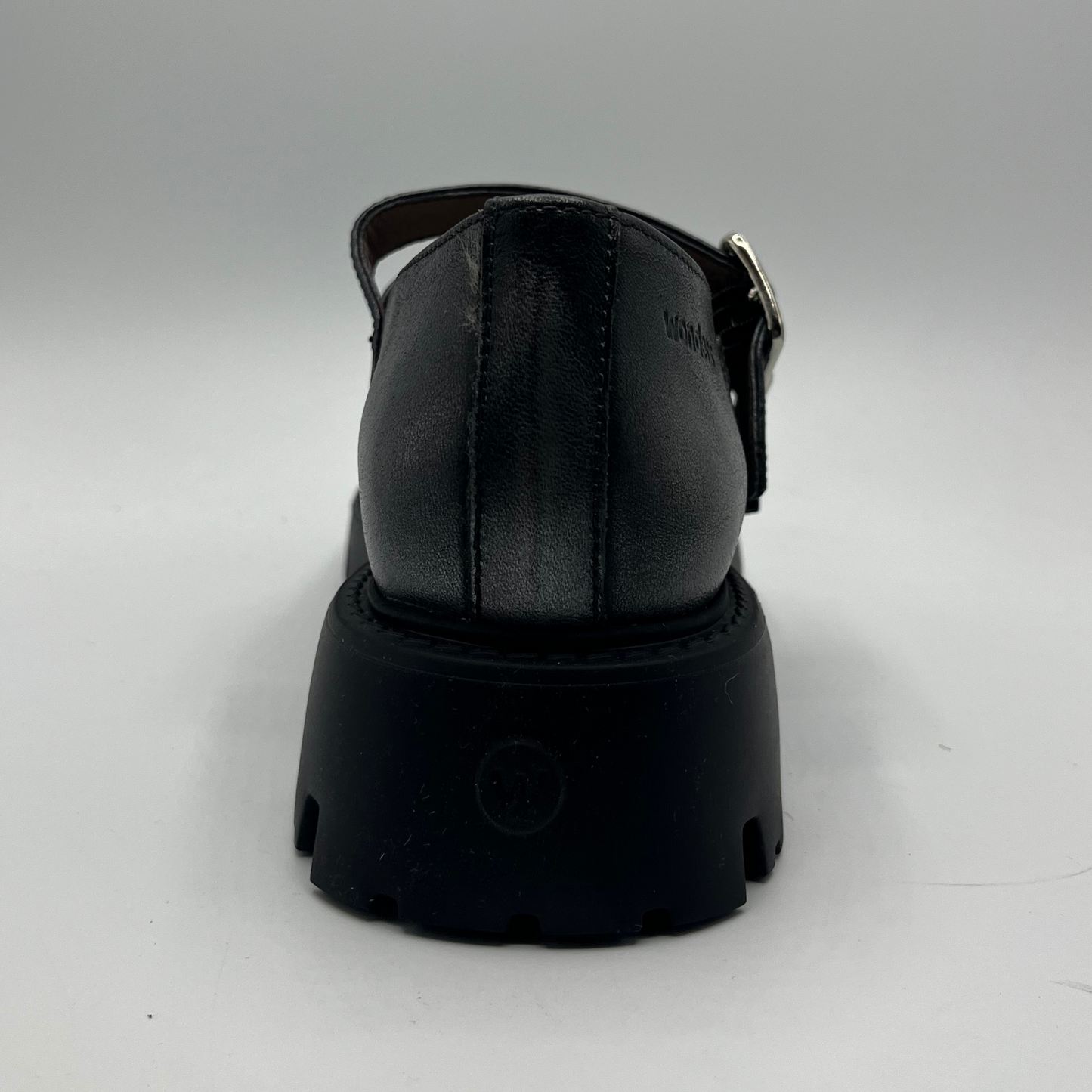 Silver shoe with a thick sole on a gray background
