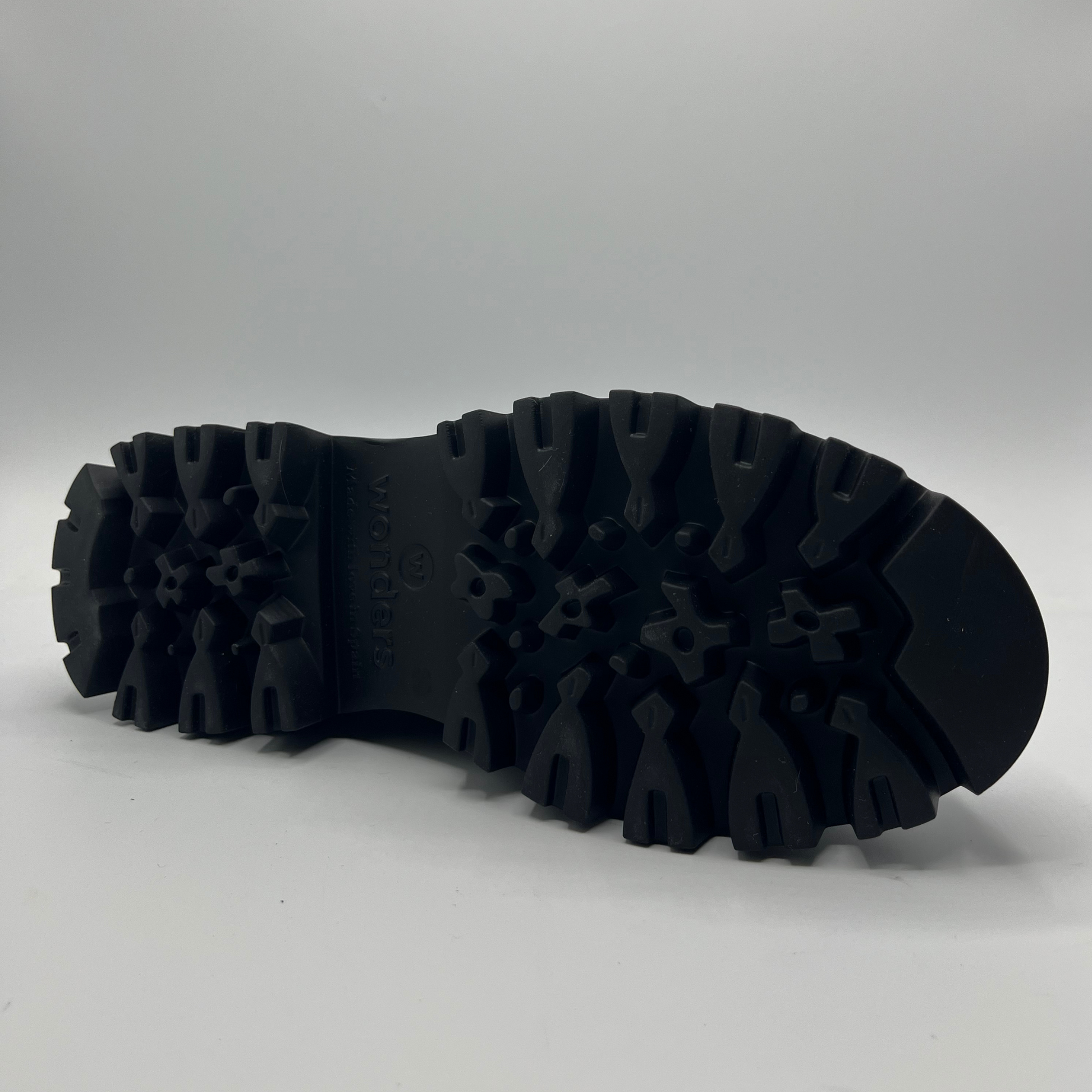 Black rubber sole of a shoe on a white background