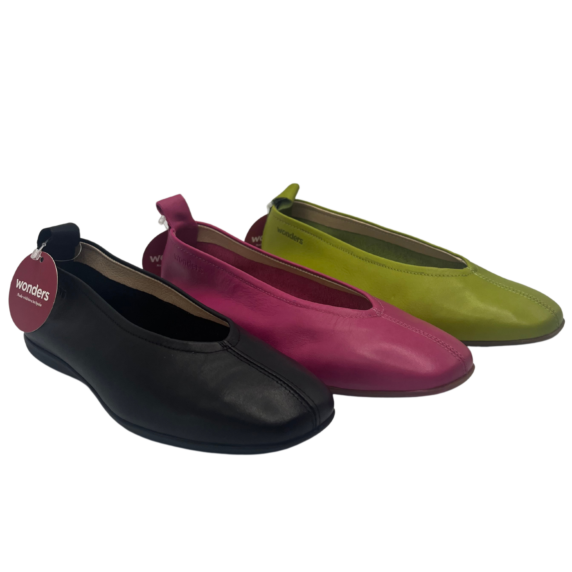 45 degree angled view of three ballet flats in a row. black, orchid and apple green. All have a leather upper and rubber outsole