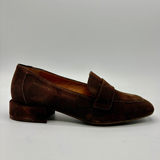 A single dark brown suede penny loafer with a low block heel, shown in profile against a neutral light gray background.