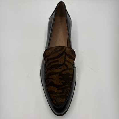 A single black leather loafer with a brown and black tiger-stripe patterned suede vamp, photographed from a top-down angle on a light gray background.