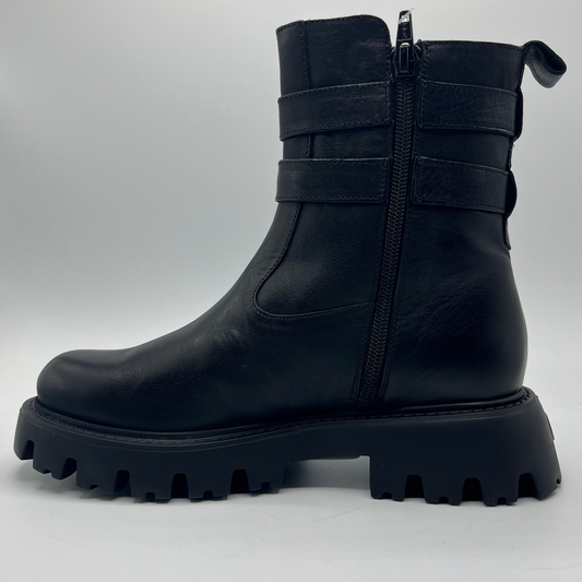 Black boot with chunky sole on a light gray background
